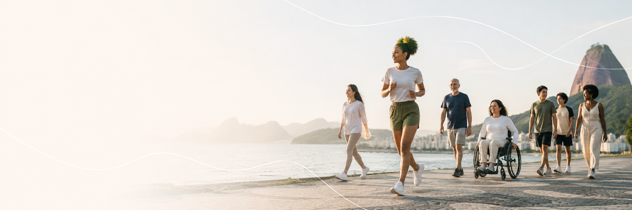 Pessoas de diferentes idades caminhando, correndo e usando cadeira de rodas à beira-mar